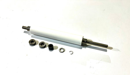 A white ZEBRA platen roller with metal shaft and several small black components placed around it, likely for installation or replacement in a thermal printer.