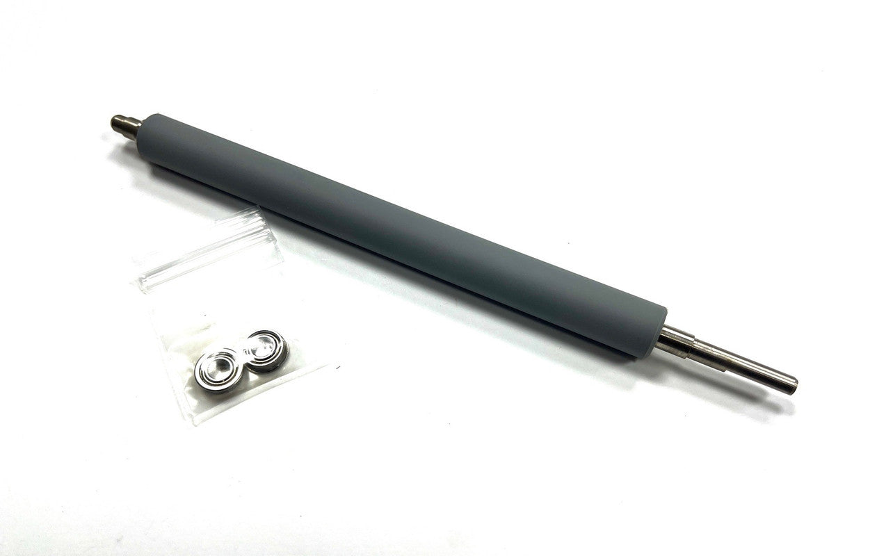 Long cylindrical rubber roller with smaller metal components on a white background