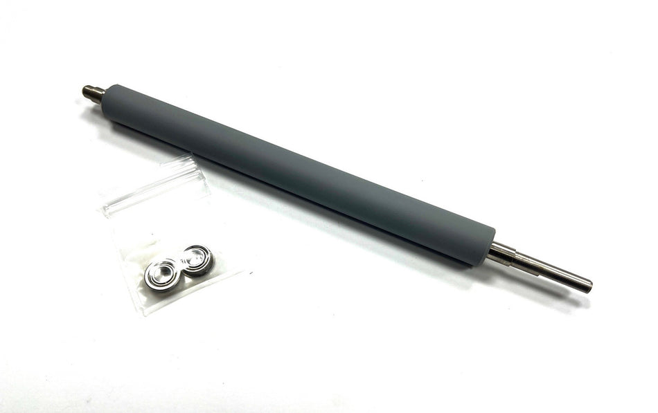 Long cylindrical rubber roller with smaller metal components on a white background