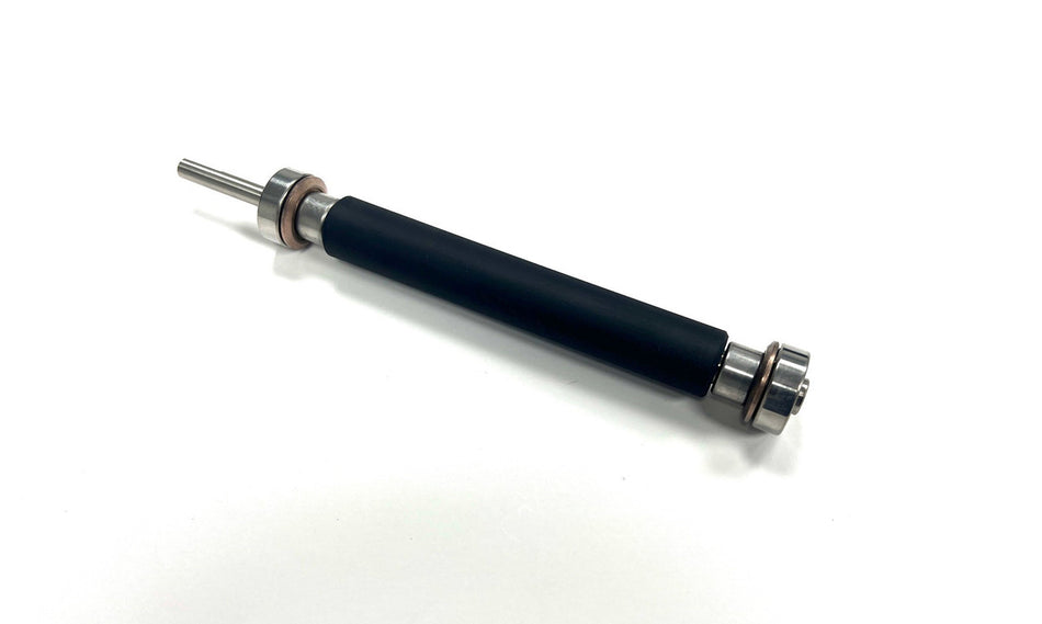Black cylindrical object with metallic ends on a white background
