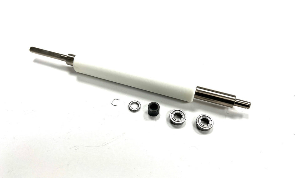 WHITE ZEBRA PLATEN ROLLER WITH FOUR METALIC AND ONE PLASTIC PIECES NEXT TO IT ON A WHITE BACKGROUND